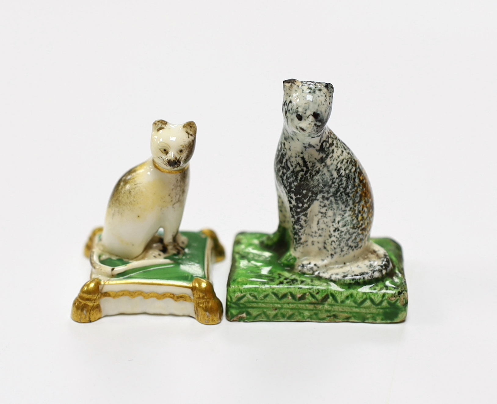 A rare Staffordshire pearlware model of a seated cat, c.1830, 5cm high and a Rockingham porcelain seated model of a cat, c.1830, iron red CL2 mark only